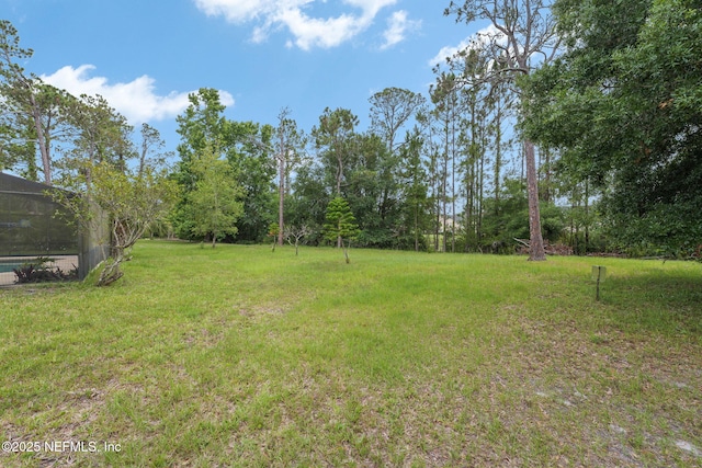 419 Sevilla Dr, Saint Augustine, FL 32086 - view of grassy yard featuring glass enclosure