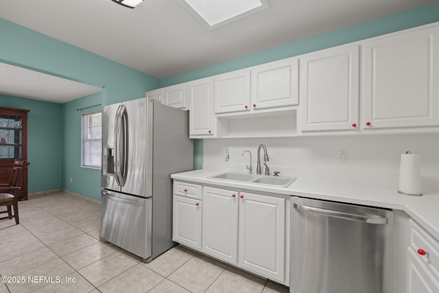 419 Sevilla Dr, Saint Augustine, FL 32086 - kitchen featuring stainless steel appliances, a sink, light countertops, and white cabinetry