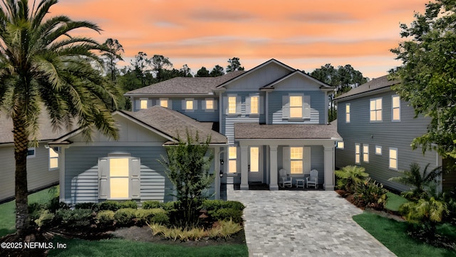 384 Freshwater Dr, Saint Johns, FL 32259 - view of front of home with board and batten siding, covered porch, decorative driveway, and a shingled roof