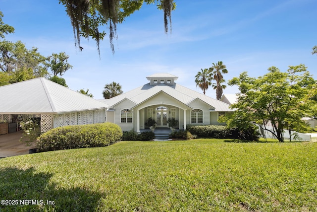 4333 Seminole St, Starke, FL 32091 - view of front facade featuring french doors, a front yard, and metal roof