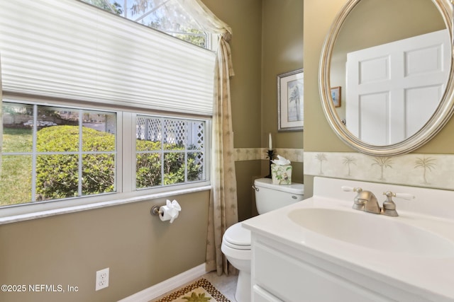 4333 Seminole St, Starke, FL 32091 - bathroom featuring toilet, plenty of natural light, vanity, and wainscoting