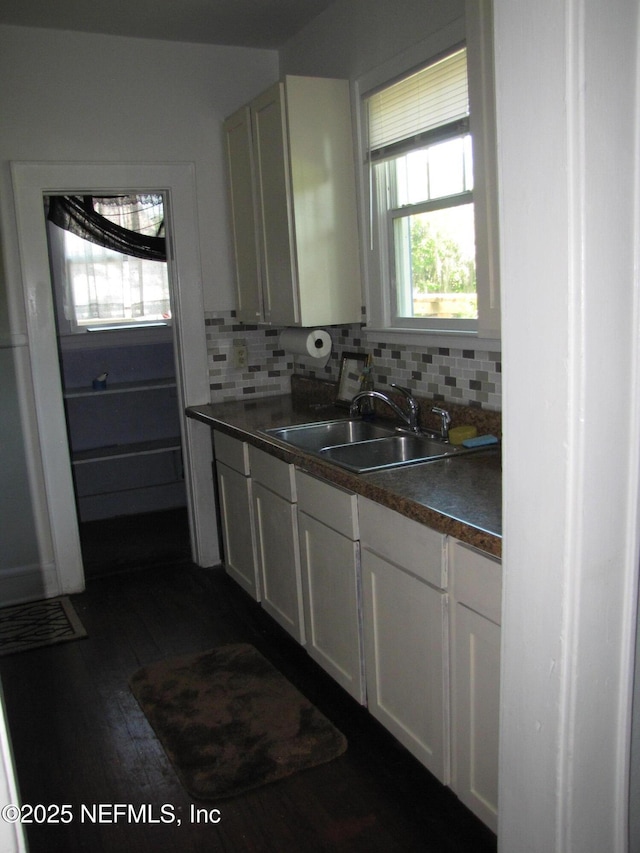 870 Allison St, Jacksonville, FL 32254 - kitchen with a sink, dark countertops, tasteful backsplash, and white cabinetry