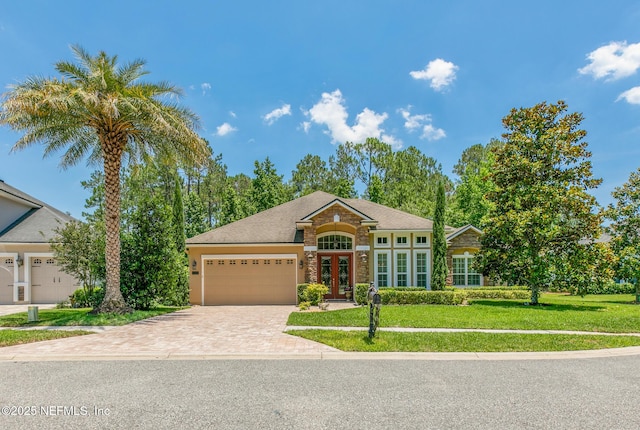 117 Pineta Way, Saint Johns, FL 32259 - view of front facade with a front yard, driveway, a garage, and french doors