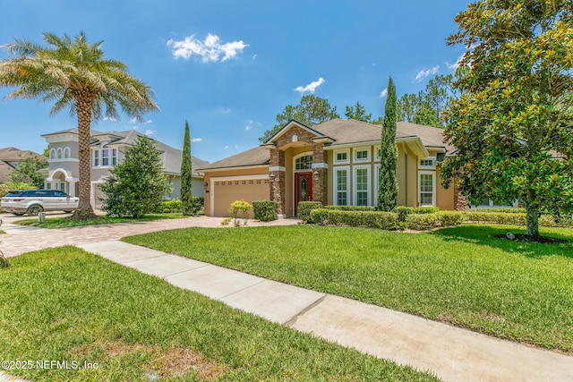 117 Pineta Way, Saint Johns, FL 32259 - view of front of property with driveway, an attached garage, a front lawn, stucco siding, and stone siding