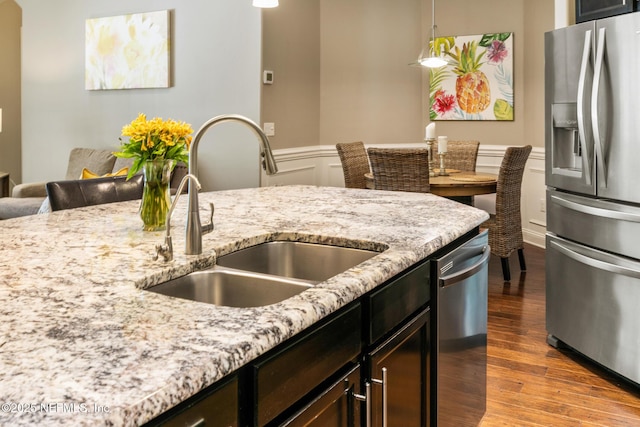 117 Pineta Way, Saint Johns, FL 32259 - kitchen featuring stainless steel appliances, a sink, wood finished floors, light stone counters, and decorative light fixtures
