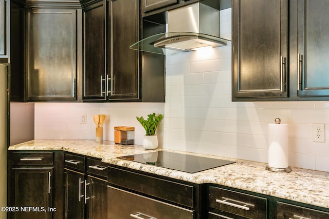 117 Pineta Way, Saint Johns, FL 32259 - kitchen featuring wall chimney range hood, decorative backsplash, black electric cooktop, and dark brown cabinetry