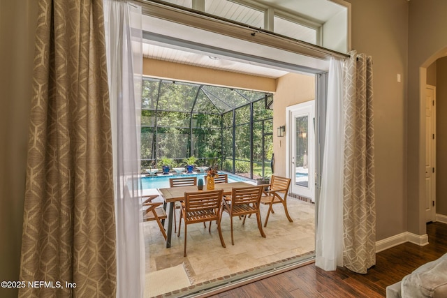 117 Pineta Way, Saint Johns, FL 32259 - dining area featuring dark wood-type flooring, arched walkways, a sunroom, and baseboards