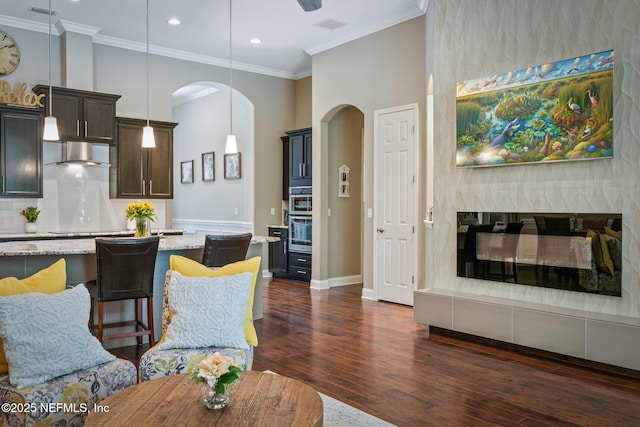 117 Pineta Way, Saint Johns, FL 32259 - living area with arched walkways, dark wood-type flooring, recessed lighting, ornamental molding, and baseboards