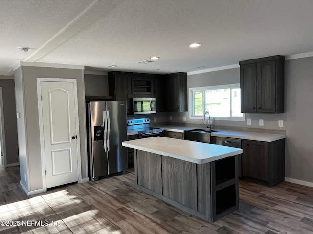 11648 E Confederate Dr, Glen St Mary, FL 32040 - kitchen featuring stainless steel appliances, a sink, light countertops, wood finished floors, and recessed lighting