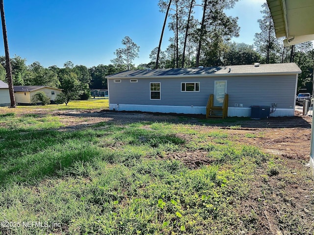 11648 E Confederate Dr, Glen St Mary, FL 32040 - rear view of house with entry steps and central AC unit
