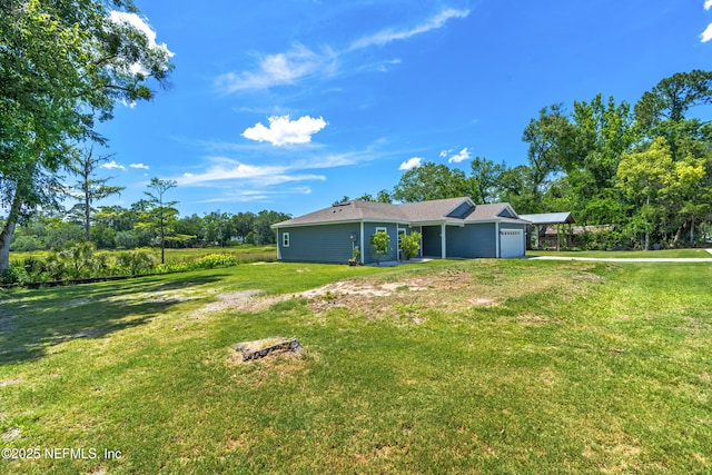 9706 Sibbald Rd, Jacksonville, FL 32219 - view of green lawn with an attached garage