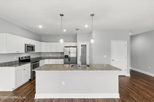 9706 Sibbald Rd, Jacksonville, FL 32219 - kitchen featuring appliances with stainless steel finishes, a sink, an island with sink, dark wood-type flooring, and white cabinetry