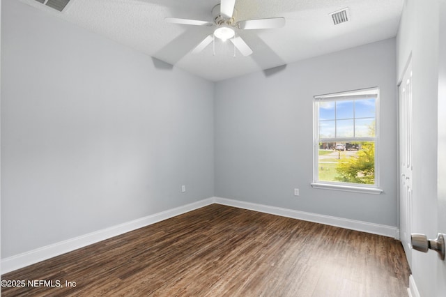 9706 Sibbald Rd, Jacksonville, FL 32219 - empty room with dark wood finished floors, baseboards, and a ceiling fan