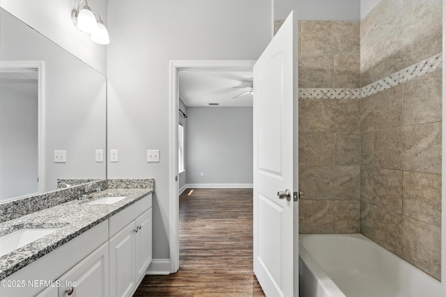 9706 Sibbald Rd, Jacksonville, FL 32219 - bathroom featuring double vanity, wood finished floors, a ceiling fan, and baseboards