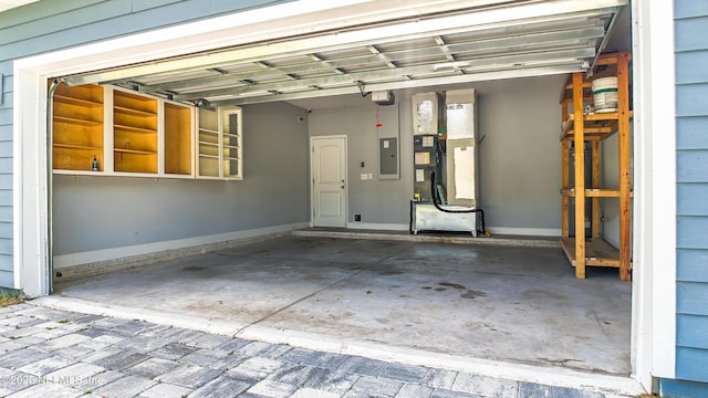 9706 Sibbald Rd, Jacksonville, FL 32219 - garage featuring electric panel, a garage door opener, and heating unit