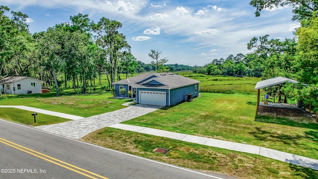 9706 Sibbald Rd, Jacksonville, FL 32219 - view of front of house featuring decorative driveway, a front yard, and view of scattered trees