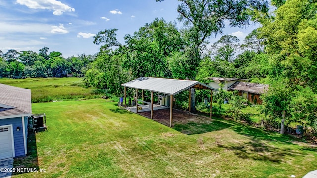 9706 Sibbald Rd, Jacksonville, FL 32219 - view of green lawn featuring a detached carport and view of scattered trees