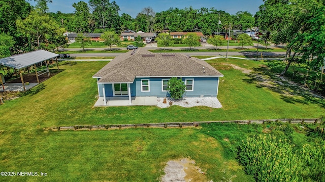 9706 Sibbald Rd, Jacksonville, FL 32219 - back of house with a lawn and roof with shingles