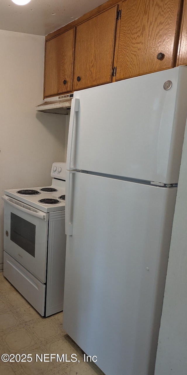 4649 Fairleigh Ave, Jacksonville, FL 32208 - kitchen with white appliances, under cabinet range hood, and brown cabinetry