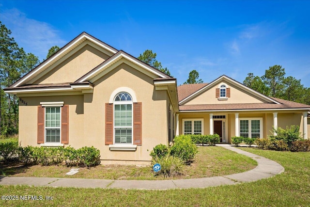 9955 Kings Crossing Dr E, Jacksonville, FL 32219 - view of front of property featuring a front yard and stucco siding