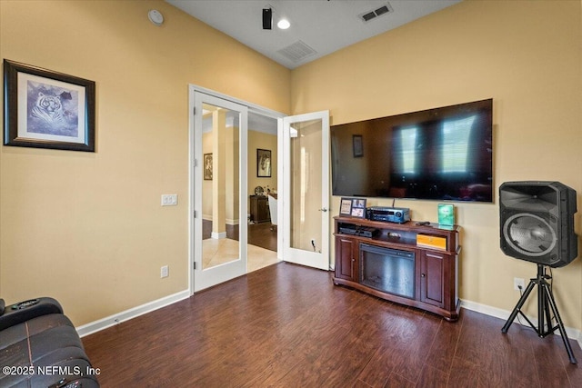 9955 Kings Crossing Dr E, Jacksonville, FL 32219 - living area featuring french doors, dark wood-style floors, and baseboards
