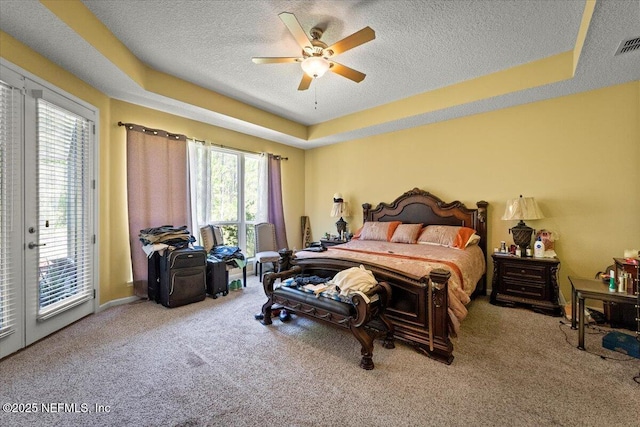 9955 Kings Crossing Dr E, Jacksonville, FL 32219 - carpeted bedroom with access to exterior, a raised ceiling, a textured ceiling, and a ceiling fan