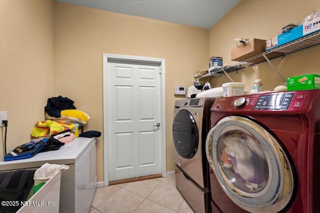 9955 Kings Crossing Dr E, Jacksonville, FL 32219 - washroom featuring washer and dryer, light tile patterned floors, and baseboards