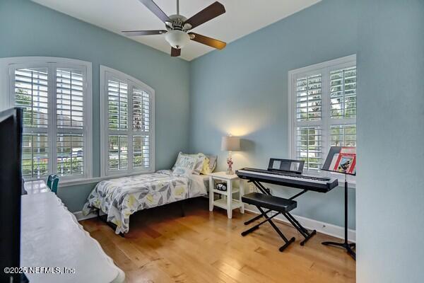167 Royal Lake Dr, Ponte Vedra, FL 32081 - bedroom with wood finished floors, a ceiling fan, and baseboards