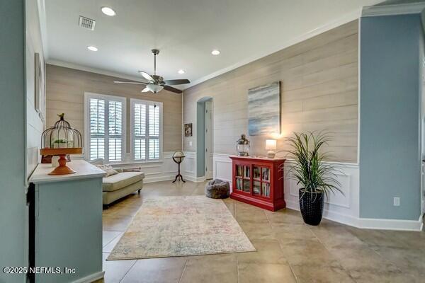 167 Royal Lake Dr, Ponte Vedra, FL 32081 - living area featuring crown molding, a decorative wall, recessed lighting, a ceiling fan, and arched walkways