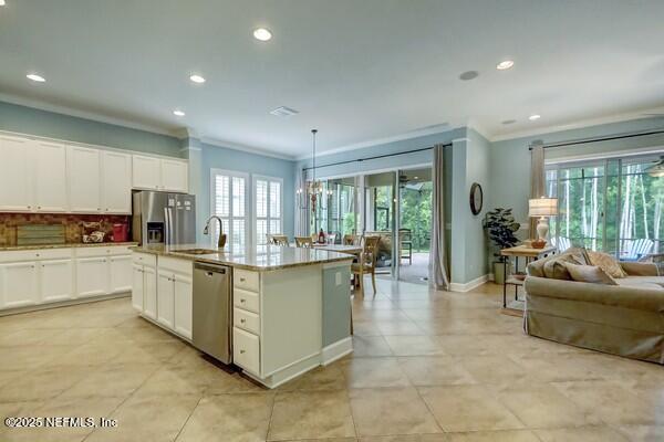 167 Royal Lake Dr, Ponte Vedra, FL 32081 - kitchen with appliances with stainless steel finishes, crown molding, open floor plan, recessed lighting, and a sink