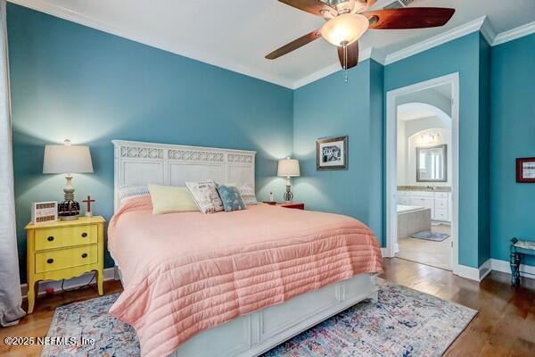 167 Royal Lake Dr, Ponte Vedra, FL 32081 - bedroom with arched walkways, ornamental molding, wood finished floors, connected bathroom, and baseboards