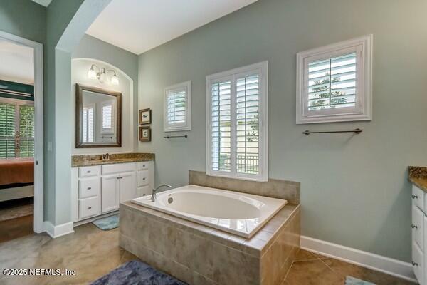 167 Royal Lake Dr, Ponte Vedra, FL 32081 - bathroom with vanity, plenty of natural light, a garden tub, and tile patterned flooring