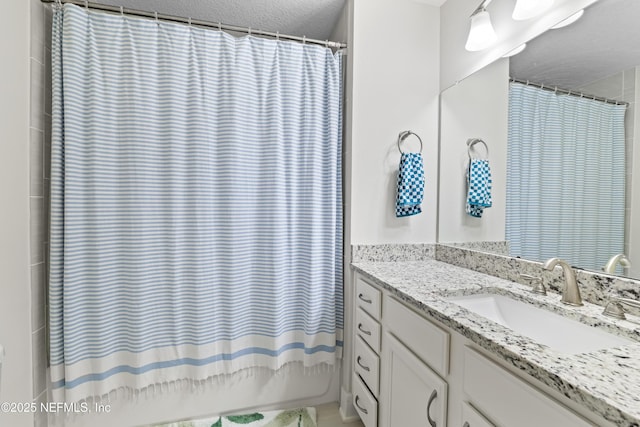 622 2nd Ave N, Jacksonville Beach, FL 32250 - full bathroom featuring vanity, a textured ceiling, and a shower with curtain