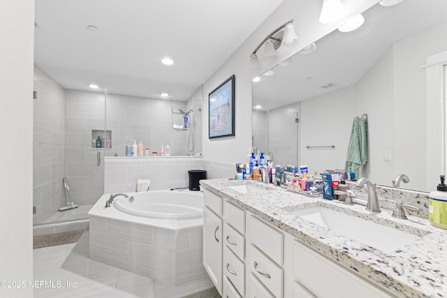 622 2nd Ave N, Jacksonville Beach, FL 32250 - full bath with a stall shower, double vanity, a bath, recessed lighting, and tile patterned floors