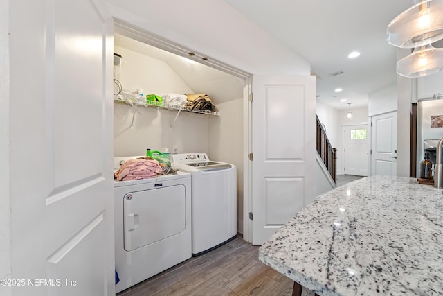 622 2nd Ave N, Jacksonville Beach, FL 32250 - laundry area featuring washing machine and dryer, wood finished floors, and recessed lighting