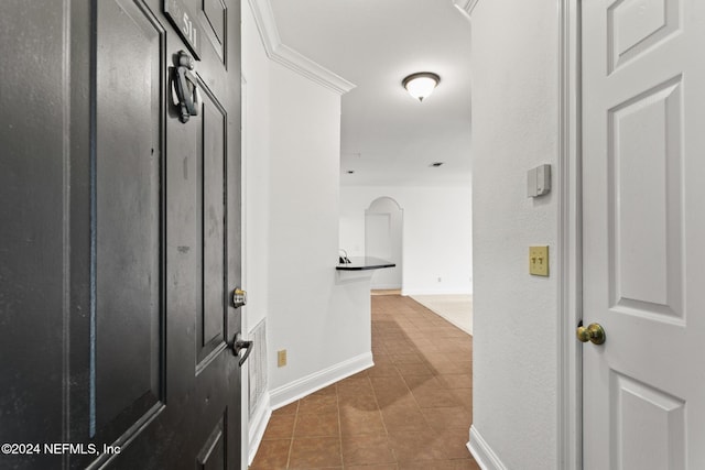13810 Sutton Park Dr N Unit 511, Jacksonville, FL 32224 - hallway featuring arched walkways, baseboards, and dark tile patterned floors