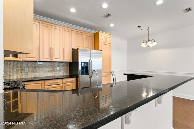 13810 Sutton Park Dr N Unit 511, Jacksonville, FL 32224 - kitchen with stainless steel fridge with ice dispenser, dark tile patterned floors, a breakfast bar area, decorative backsplash, and recessed lighting