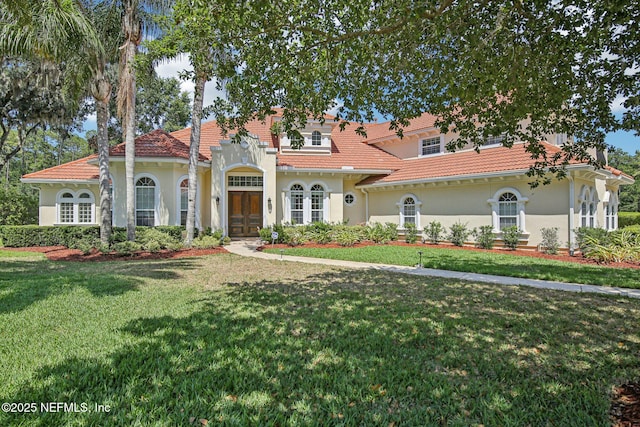 2579 Woodgrove Rd, Fleming Island, FL 32003 - mediterranean / spanish-style home with a front lawn, stucco siding, and a tile roof