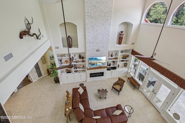 2579 Woodgrove Rd, Fleming Island, FL 32003 - living area with a towering ceiling, built in features, and a fireplace