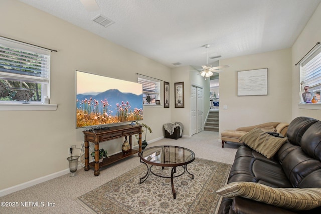 2579 Woodgrove Rd, Fleming Island, FL 32003 - living room with ceiling fan, carpet flooring, baseboards, and stairs