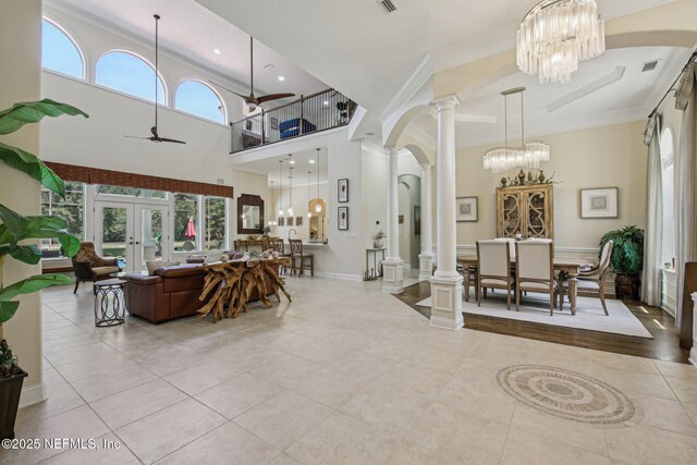 2579 Woodgrove Rd, Fleming Island, FL 32003 - tiled living area with a chandelier, ornate columns, arched walkways, plenty of natural light, and crown molding