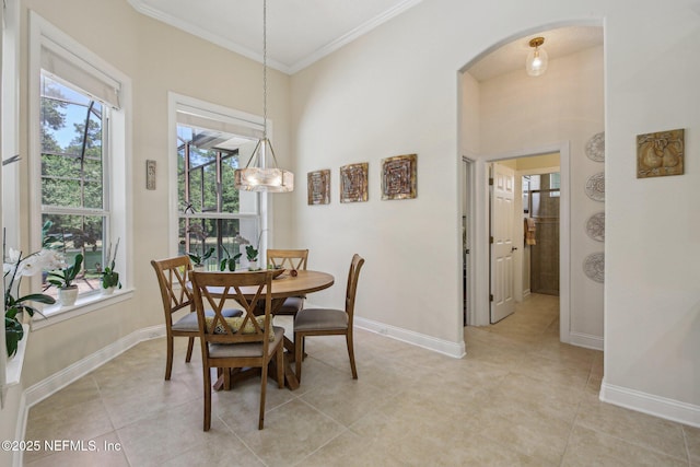 2579 Woodgrove Rd, Fleming Island, FL 32003 - dining area featuring arched walkways, ornamental molding, baseboards, light tile patterned flooring, and a towering ceiling