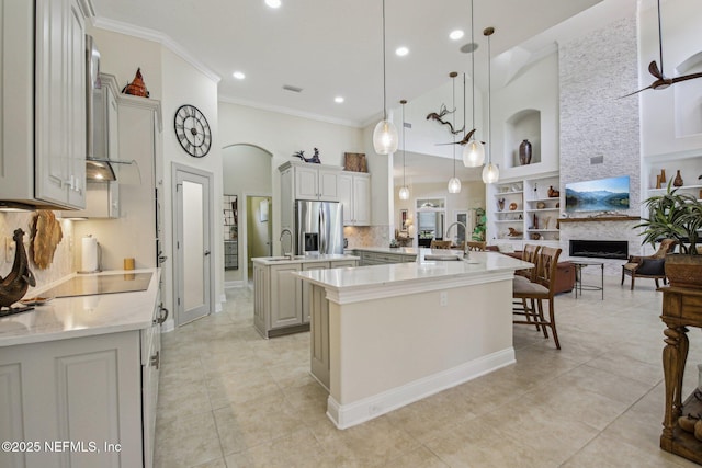 2579 Woodgrove Rd, Fleming Island, FL 32003 - kitchen with stainless steel fridge with ice dispenser, a large island with sink, open floor plan, black electric cooktop, and a sink