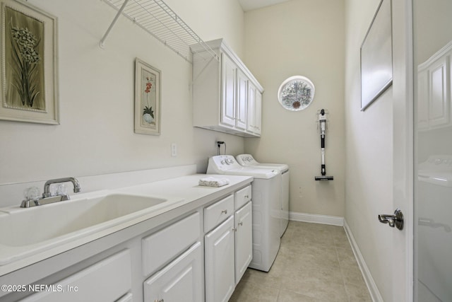 2579 Woodgrove Rd, Fleming Island, FL 32003 - laundry area featuring separate washer and dryer, cabinet space, light tile patterned floors, and baseboards