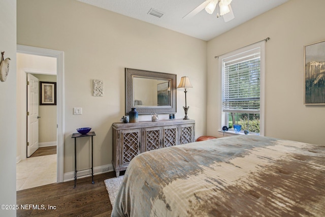 2579 Woodgrove Rd, Fleming Island, FL 32003 - bedroom with wood finished floors, a ceiling fan, and baseboards
