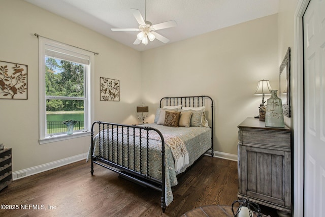 2579 Woodgrove Rd, Fleming Island, FL 32003 - bedroom featuring baseboards, dark wood finished floors, and ceiling fan