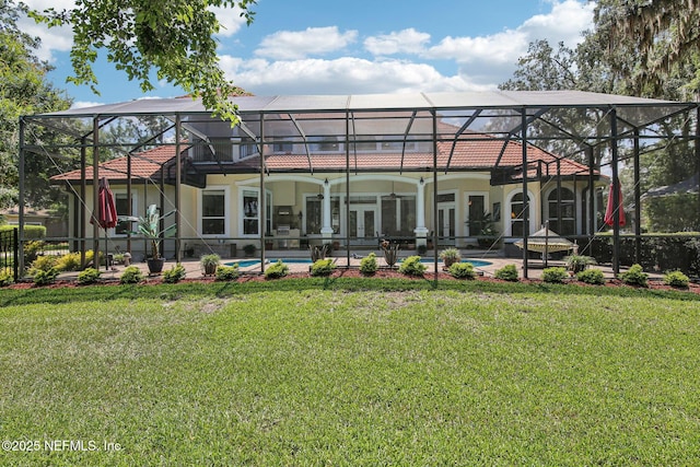 2579 Woodgrove Rd, Fleming Island, FL 32003 - back of property featuring a lanai, a lawn, french doors, stucco siding, and a patio