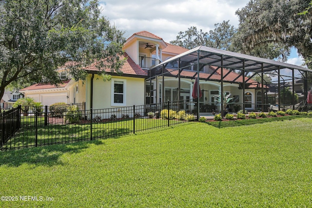 2579 Woodgrove Rd, Fleming Island, FL 32003 - rear view of house with a ceiling fan, stucco siding, a garage, a lanai, and a tile roof