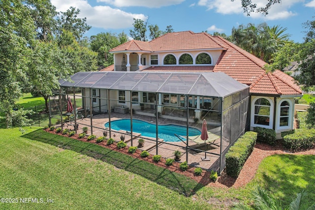 2579 Woodgrove Rd, Fleming Island, FL 32003 - back of house featuring a patio area, an outdoor pool, a tile roof, a yard, and a lanai