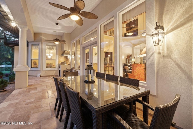 2579 Woodgrove Rd, Fleming Island, FL 32003 - dining space featuring decorative columns, stone tile flooring, a ceiling fan, a textured wall, and french doors